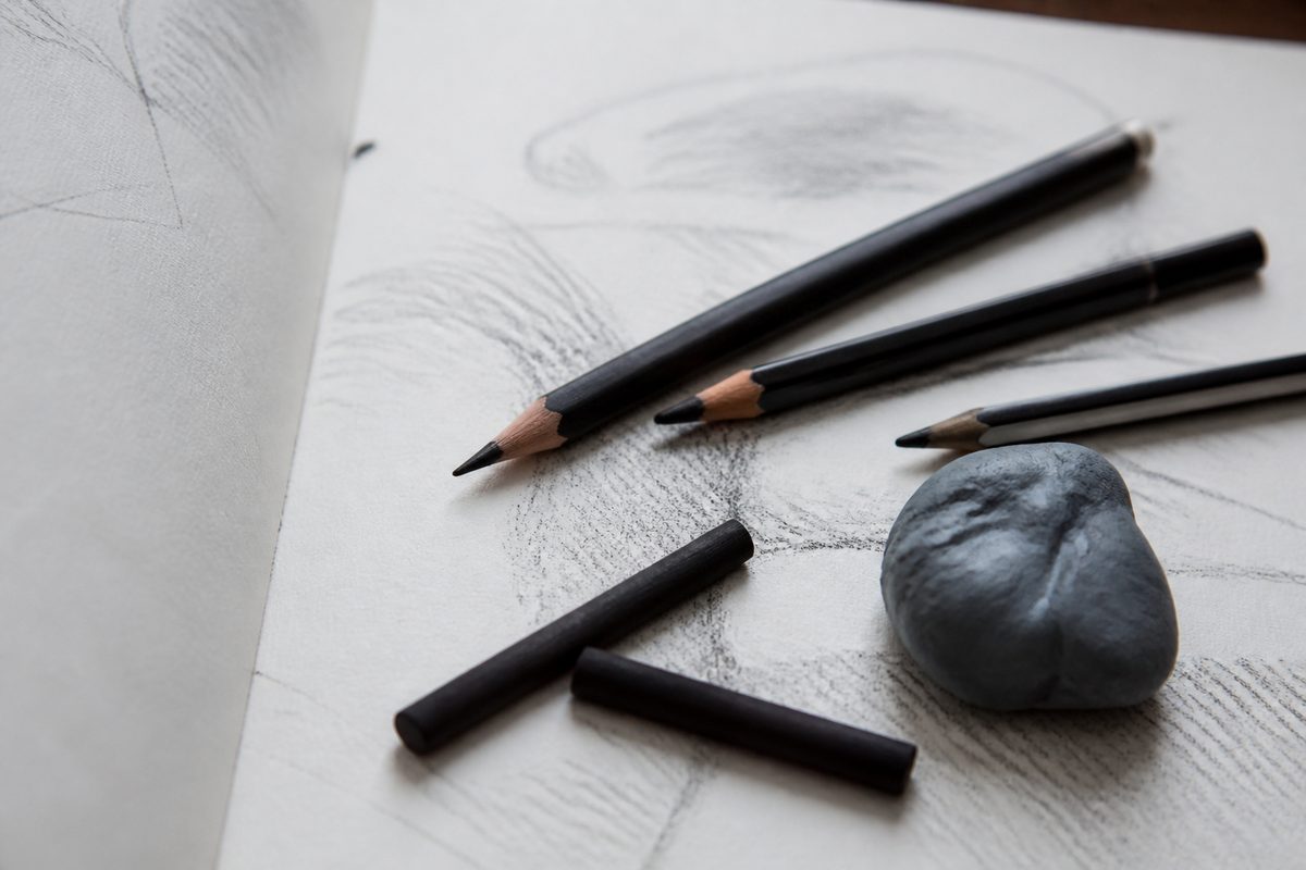 Charcoal sticks and kraft paper with gesture drawings